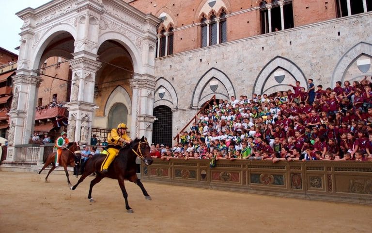 In front of the Torre di Mangia in the Piazza il Campo for the Siena Palio :: Bike Florence & Tuscany